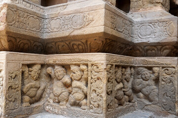 Carving of Dwarf-like Yakshas in Temple. Sandstone relief carving of ancient mythological sculptures on the wall of historic Kailasanathar temple in Kanchipuram.