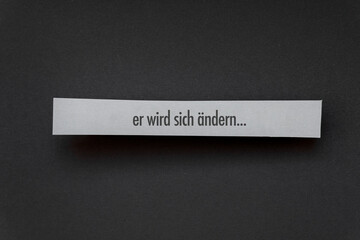 Er wird sich ändern -Botschaften auf einem weißen Papierstreifen