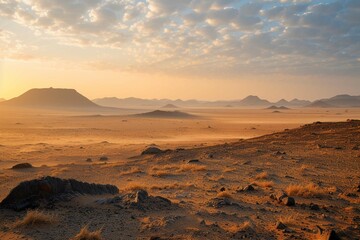 Fototapeta na wymiar Safari and travel to Africa, extreme adventures or science expedition in a stone desert. Sahara desert at sunrise, mountain landscape with dust on skyline, hills and traces of the off-road car