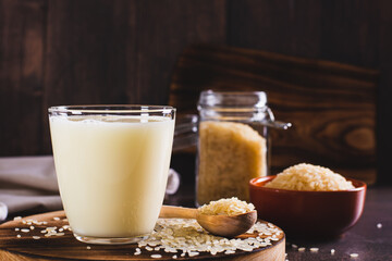 Lactose-free rice milk in a glass and rice cereal on the table
