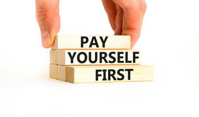 Pay yourself first symbol. Concept words Pay yourself first on beautiful wooden blocks. Beautiful white table white background. Businessman hand. Business and pay yourself first concept. Copy space.