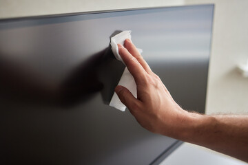 cleaning pc monitor an hand hold a rag