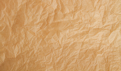 Crumpled yellow craft paper background.