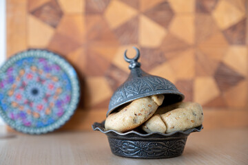 Arabic sweets with dates on arabesque background with arabian decorations