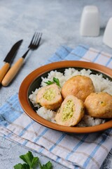 Step-by-step cooking of meatballs stuffed with feta and pesto sauce. Step six, meatballs stuffed with feta cheese and garnished with rice in a ceramic bowl. Step-by-step recipes.