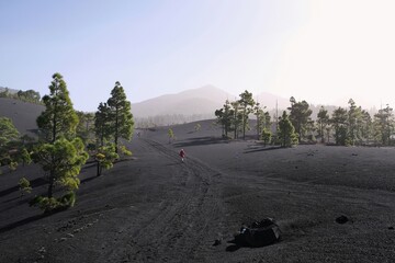 Silhouettes of hiking tourists  and amazing volcanic scenery around volcan Montana Quemada (Volcan...