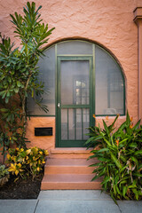 Peach colored vintage building detail exterior with arched windows and doors in the color of peach...