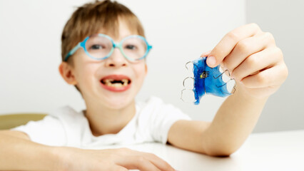 A boy with a tooth alignment plate