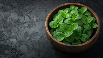 Fresh Green Mint Leaves in Wooden Bowl on Dark Surface