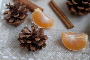 christmas still life with pine cones, orange slices and cinnamon