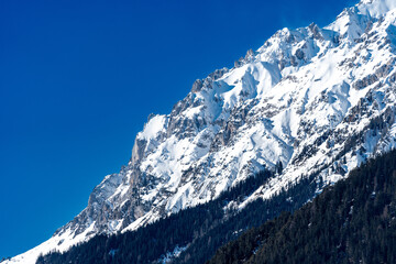 snow covered mountains under a clear blue sky - 722374019