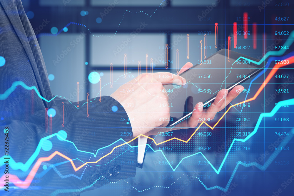 Poster close up of businessman hands using tablet with glowing forex chart on blurry bokeh office interior 