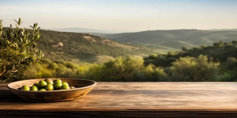 Türaufkleber Plate with olives on a wooden table, against a background of olive trees. Generative AI © 22_monkeyzzz