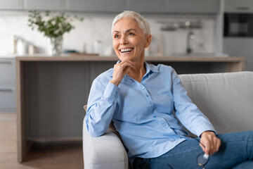 joyful european mature woman with stylish haircut looking aside indoors