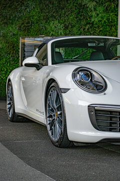 White Porsche 911 Targa front view three quarters, cropped, headlight focused shot - High Resolution Image
