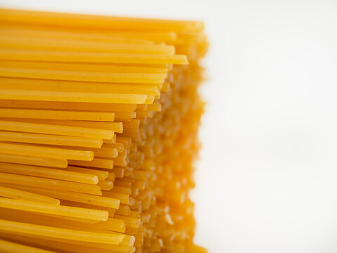 Spaghetti on a white background. Raw spaghetti close-up.