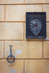 Ornaments at the wall on Contrada della Pantera building, Siena, Italy