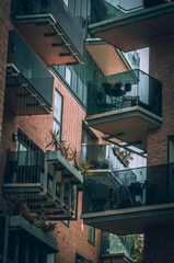 Web of glass and steel balconies in Brighton new brick buildings, East Sussex, England