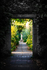 Old stone arch entrance to Preston Manor Garden on last sunny day of the autumn, Brighton, East...