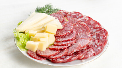 slicing sausage and cheese in a plate