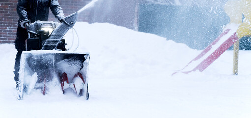 a man cleans snow with a snow plow outside