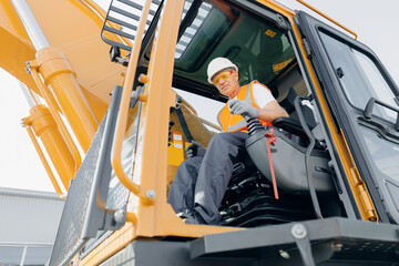 Industry worker portrait. Man driver builder operate crane or excavator at construction site