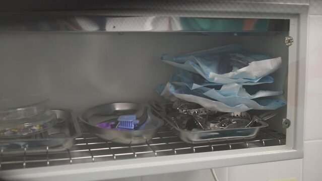 Man is opening, closing door of UV germicidal chamber with many tools