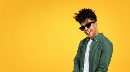 Stylish young african american guy wearing sunglasses