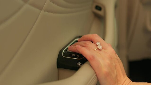 a hand in a medical glove presses the air recirculation button in the car
