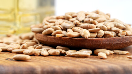 peeled sunflower seeds and a bottle of oil