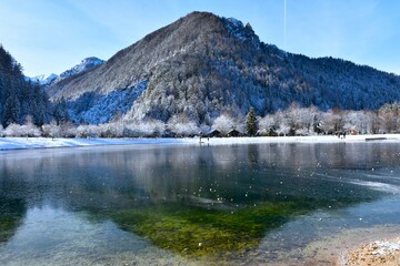 Forest covered hill above lake Jasna in Gorenjska, Slovenia in winter