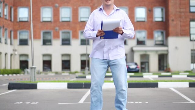 Man in jeans drive on self-balancing scooter and look in folder