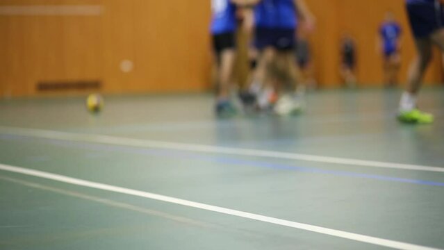Sportsmen are playing in a volleyball, view from floor. 