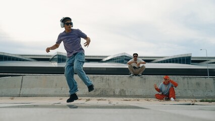 Group of skilled break dancer perform street dance with friend looking and cheering at him....