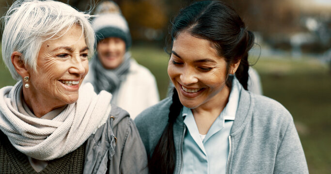 Caregiver, team and senior friends walking outdoor of a nursing home talking in a conversation for support and trust. Care, speaking and nurse exercise with elderly people for wellness and health