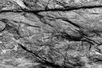 Grunge old stone background with dark cracks, great for your design and texture background. Horizontal black and white image.