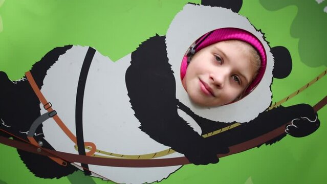 Girl of head in the hole instead of the muzzle of the panda climber
