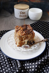 Multicolored cake, chocolate-poppy cake with cream