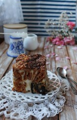 Multicolored cake, chocolate-poppy cake with cream