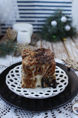 Multicolored cake, chocolate-poppy cake with cream