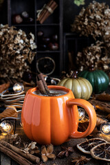 Pumpkin spice latte in mug  on wooden table, selective focus