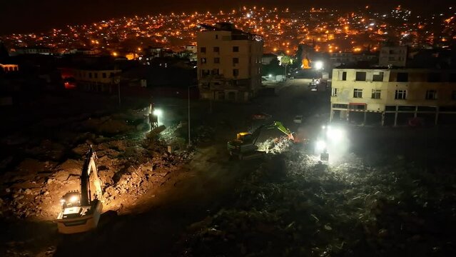 Houses destroyed in the earthquake and debris removal works