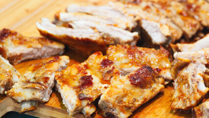 hot fried pork meat on ribs on a wooden board