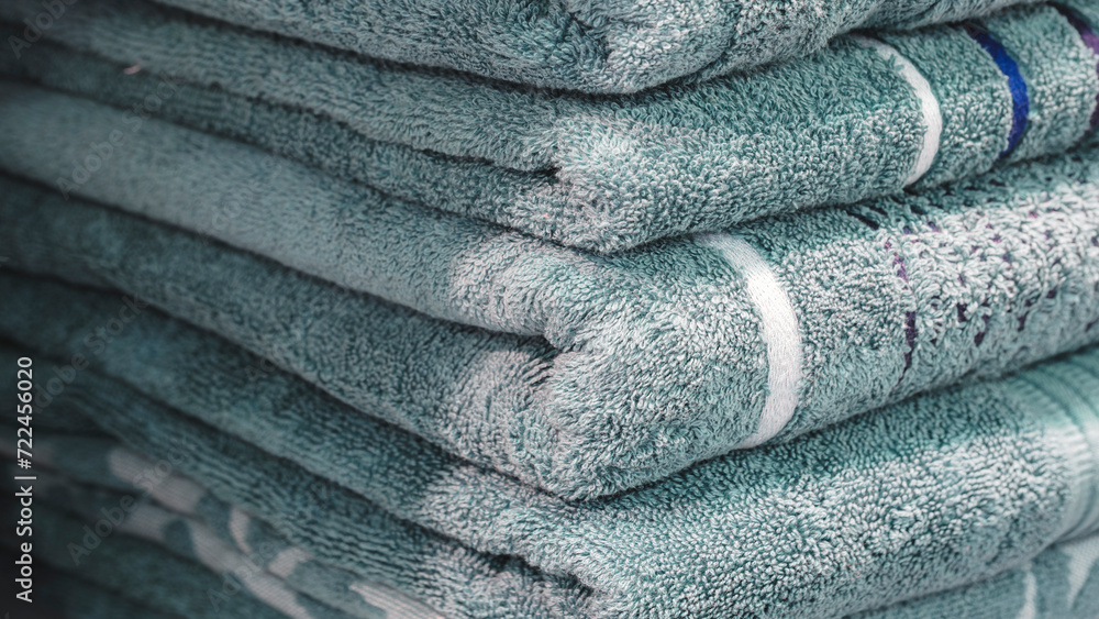 Poster stack of turquoise terry towels on a shelf