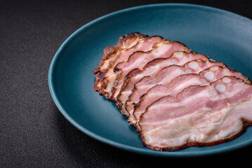 Delicious fresh pancetta or bacon with salt and spices cut into thin slices