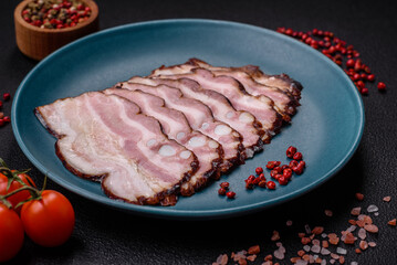 Delicious fresh pancetta or bacon with salt and spices cut into thin slices