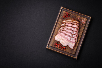 Delicious fresh pancetta or bacon with salt and spices cut into thin slices