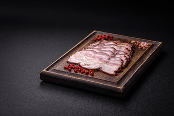 Delicious fresh pancetta or bacon with salt and spices cut into thin slices