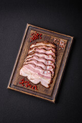 Delicious fresh pancetta or bacon with salt and spices cut into thin slices