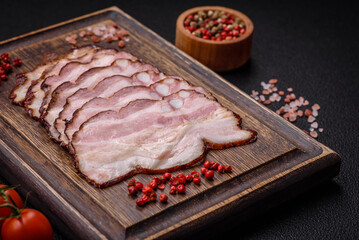 Delicious fresh pancetta or bacon with salt and spices cut into thin slices